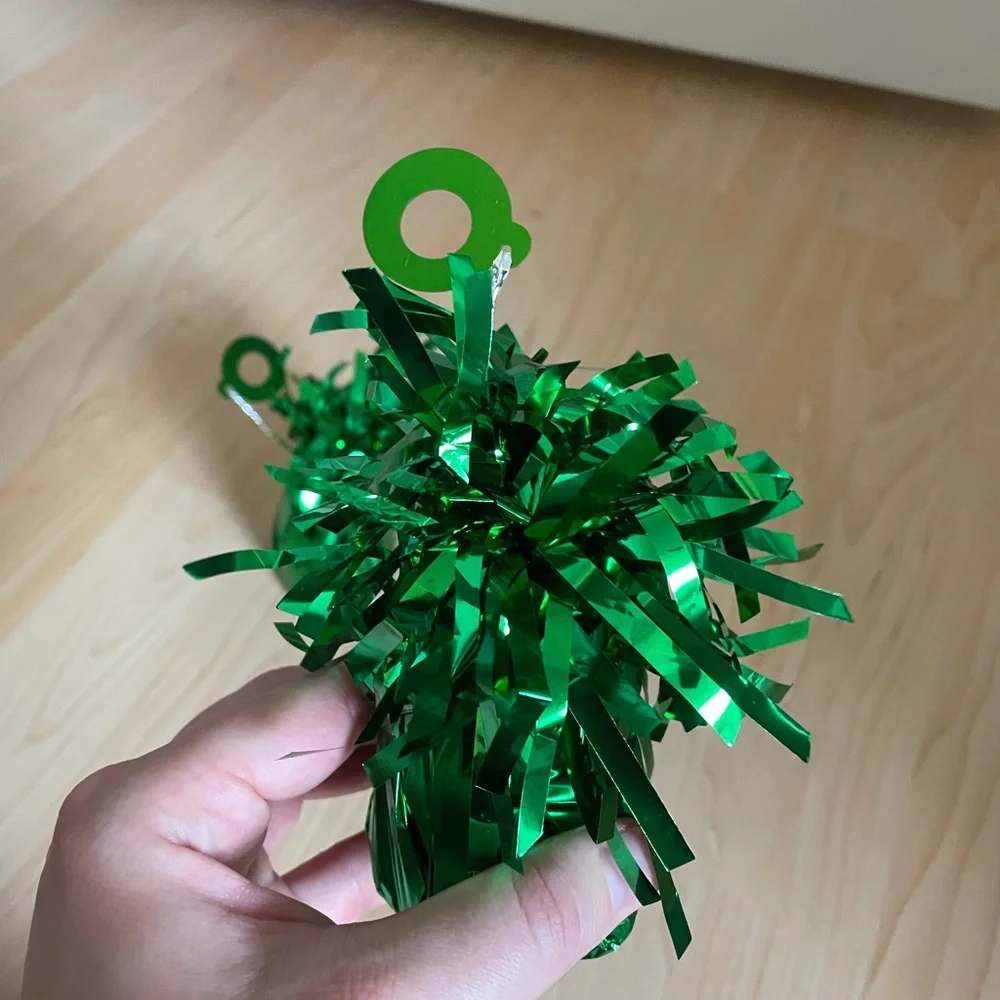 Two balloon weights in green metallic